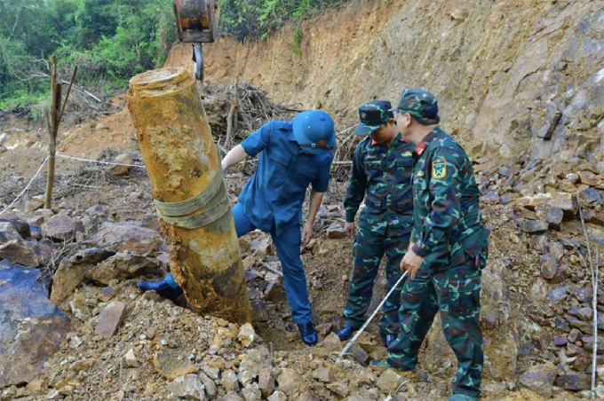 Quả bom được lực lượng chức năng đưa lên khỏi mặt đất, ngày 4/7. Ảnh: Hùng Lê
